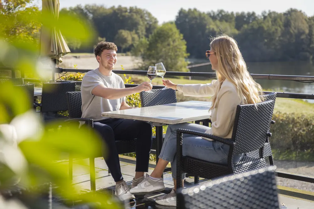 Two guests on the BØFF terrace, overlooking the lake