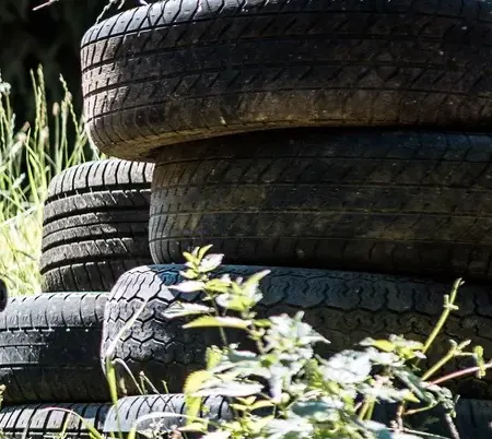 Stacked car tyres as cover in the tall grass on the playing field