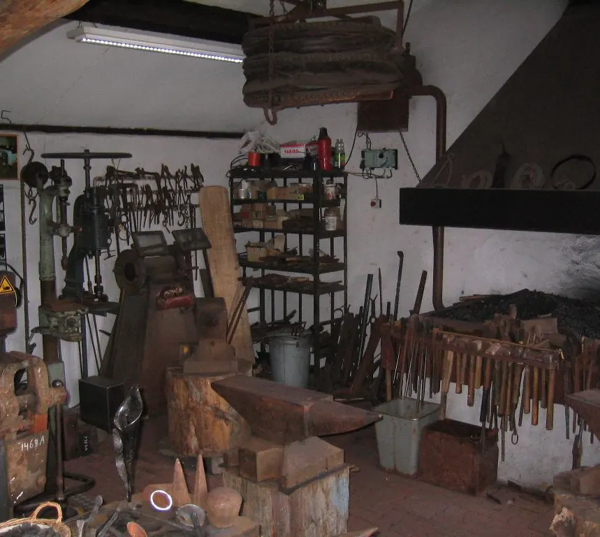 Anvils, hammers and the forge in the smithy of De Locht museum village
